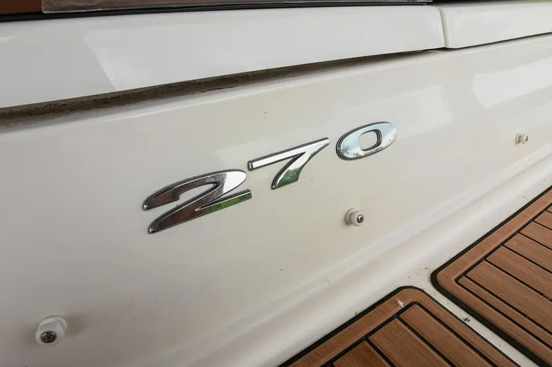 Slide: The Image of 2016 Sea Ray 270 Sundeck boat emblem on white surface. - 7