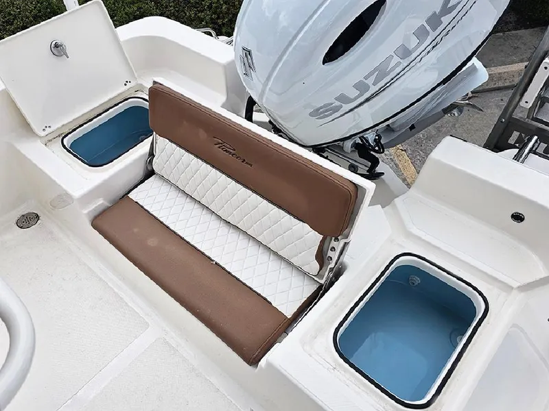 Slide: The Image of 2025 Pioneer 220 Bay Sport boat interior with Suzuki engine, featuring cushioned seating and storage compartments. - 11