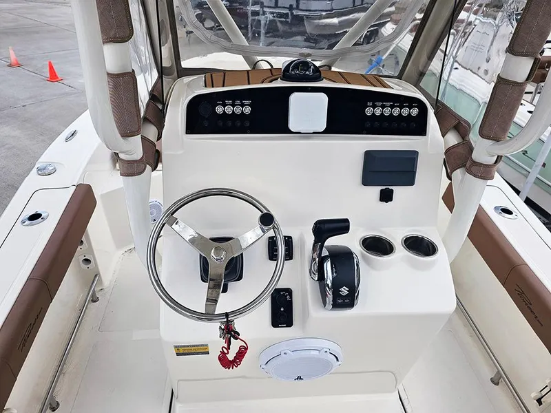 Slide: The Image of 2025 Pioneer 220 Bay Sport boat console with steering wheel and controls. - 13