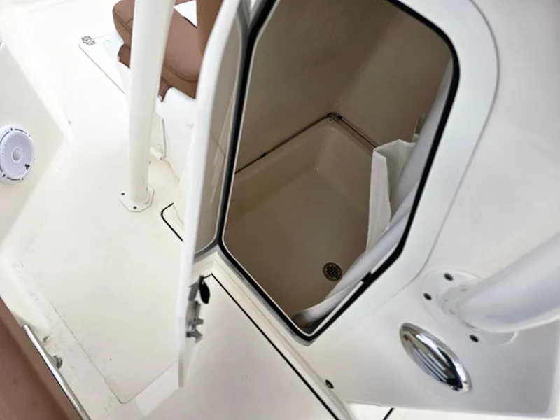 Slide: The Image of 2025 Pioneer 220 Bay Sport boat interior with open storage compartment and seating area. - 16