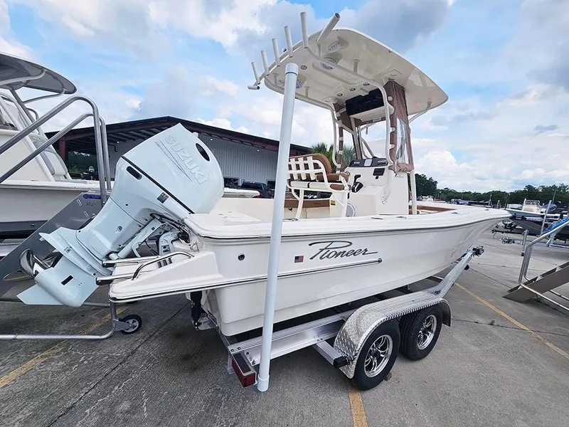 Slide: The Image of 2025 Pioneer 220 Bay Sport boat on trailer, featuring outboard motor and T-top. - 3