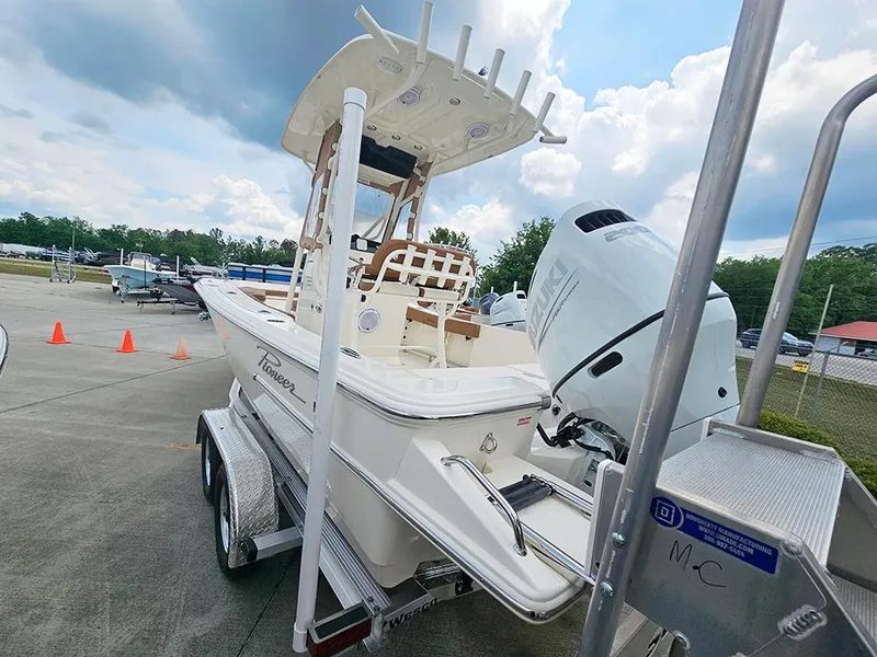 Slide: The Image of 2025 Pioneer 220 Bay Sport boat on trailer, outdoor setting, cloudy sky. - 7
