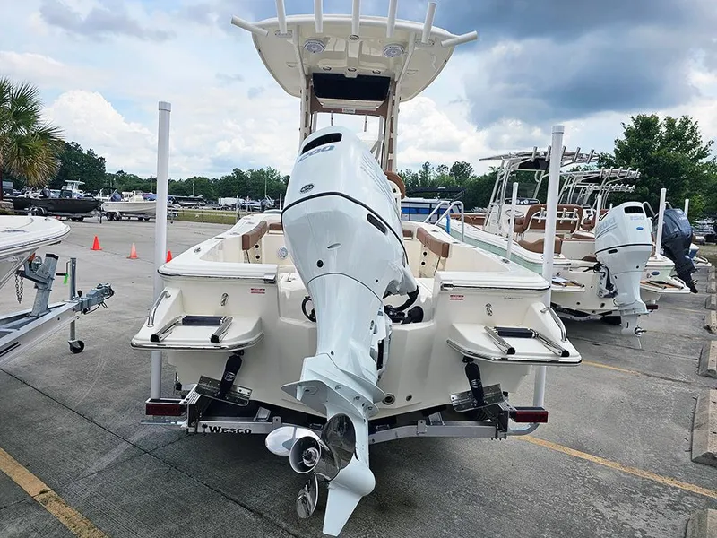 Slide: The Image of 2025 Pioneer 220 Bay Sport boat with powerful outboard motor, parked outdoors. - 8