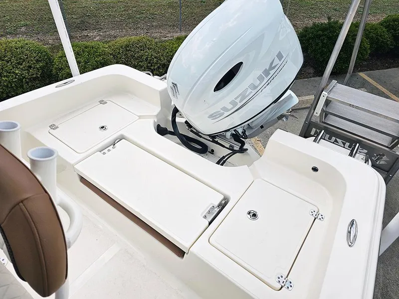 Slide: The Image of 2025 Pioneer 220 Bay Sport boat with Suzuki outboard motor, featuring spacious deck and storage compartments. - 9