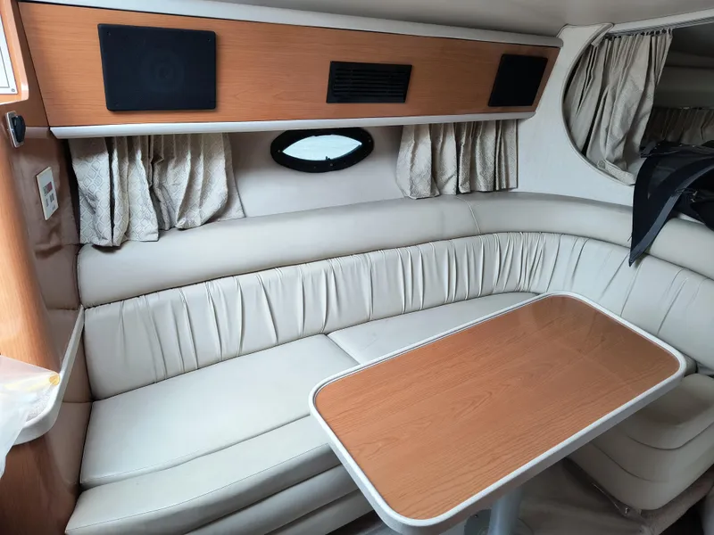 Slide: The Image of 2001 Regal Commodore 3260 interior with beige seating and wooden table. - 14