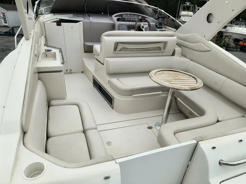 Slide: The Image of 2001 Regal Commodore 3260 boat interior with beige seating and round table. - 3
