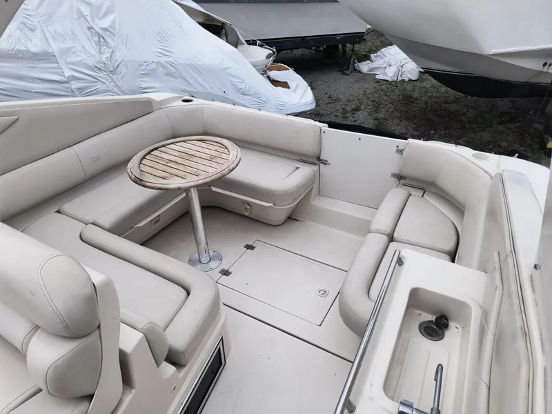 Slide: The Image of 2001 Regal Commodore 3260 boat interior with beige seating and a wooden table. - 4