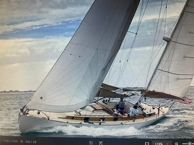 The Image of Sailing yacht Herreshoff 42, 2003 model, navigating ocean waters under cloudy skies. - 0