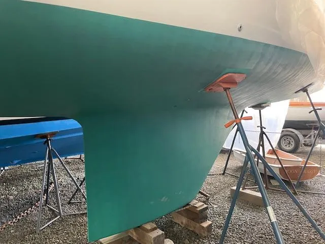 Slide: The Image of Herreshoff 42 sailboat hull, 2003 model, supported on stands in a boatyard. - 15