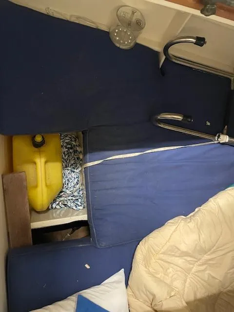 Slide: The Image of Interior of 2003 Herreshoff 42 boat with blue cushions and yellow container. - 16