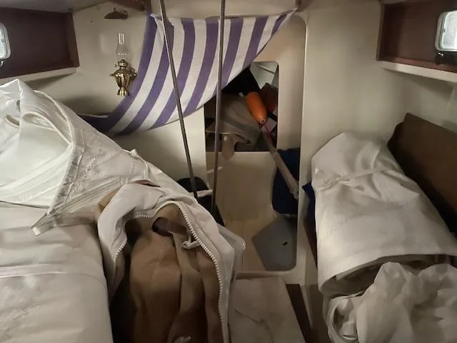 Slide: The Image of Interior of a 2003 Herreshoff 42 sailboat with striped fabric and nautical decor. - 5