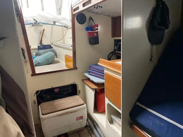 Slide: The Image of Interior of 2003 Herreshoff 42 sailboat, featuring storage, seating, and nautical equipment. - 7