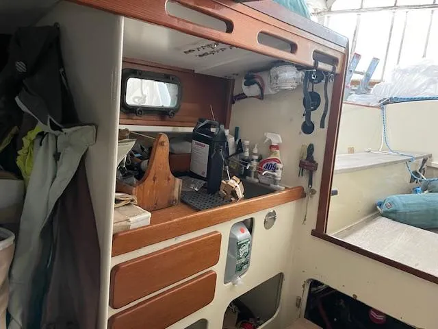 Slide: The Image of Interior of a 2003 Herreshoff 42 sailboat with wooden cabinetry and nautical equipment. - 8