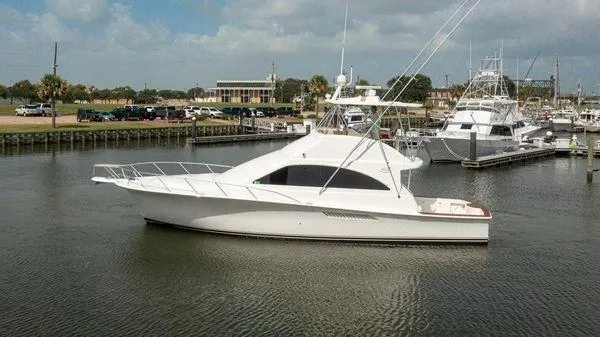 The Image of 2008 Ocean Yachts 46SS in marina, side view, calm waters, partly cloudy sky. - 0