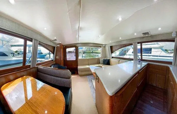 Slide: The Image of Luxurious interior of 2008 Ocean Yachts 46SS with spacious seating and elegant wood finishes. - 10