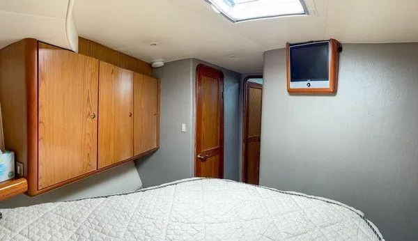 Slide: The Image of Interior of 2008 Ocean Yachts 46SS, featuring wood cabinets and a mounted TV. - 18