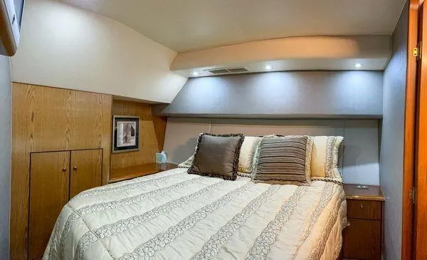 Slide: The Image of Luxurious bedroom interior of 2008 Ocean Yachts 46SS with cozy bedding and wooden accents. - 19