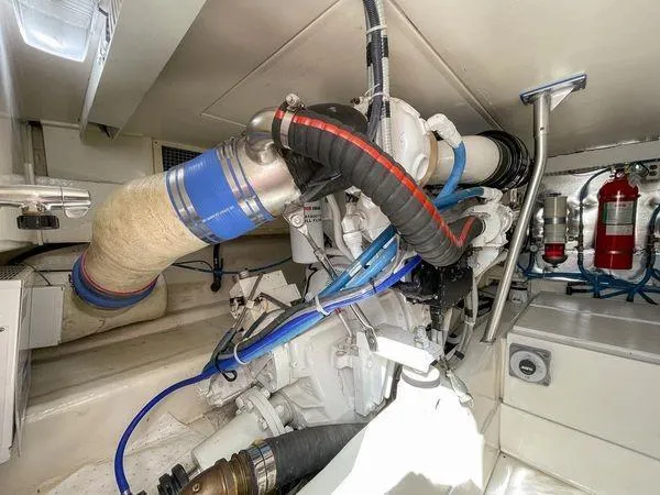 Slide: The Image of Engine room of 2008 Ocean Yachts 46SS with visible hoses and fire extinguishers. - 23