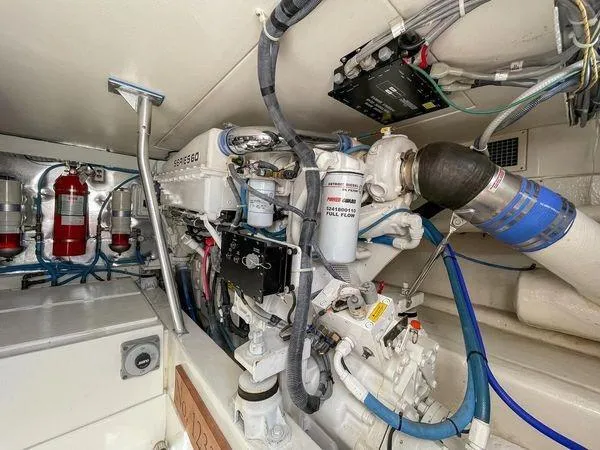 Slide: The Image of Engine room of 2008 Ocean Yachts 46SS, showcasing detailed mechanical components and fire extinguishers. - 24