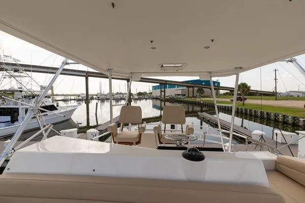 Slide: The Image of 2008 Ocean Yachts 46SS yacht interior with marina view, featuring seating and helm station. - 3