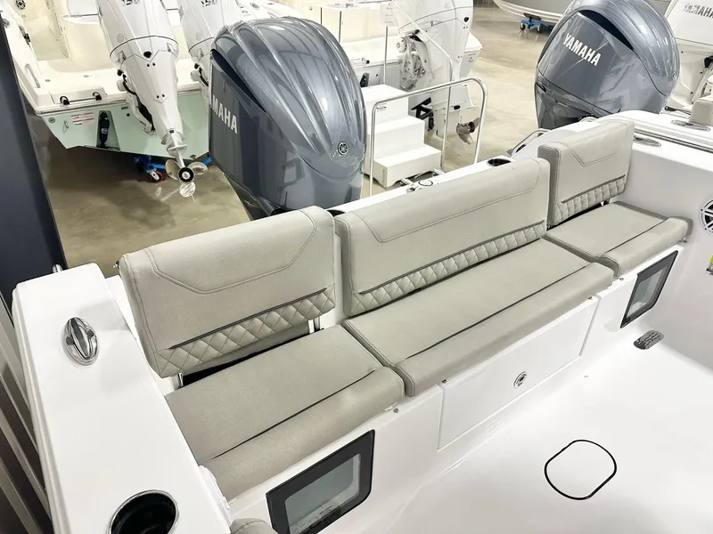 Slide: The Image of 2025 Sportsman Heritage 231 Center Console boat with cushioned seating and Yamaha engines. - 10