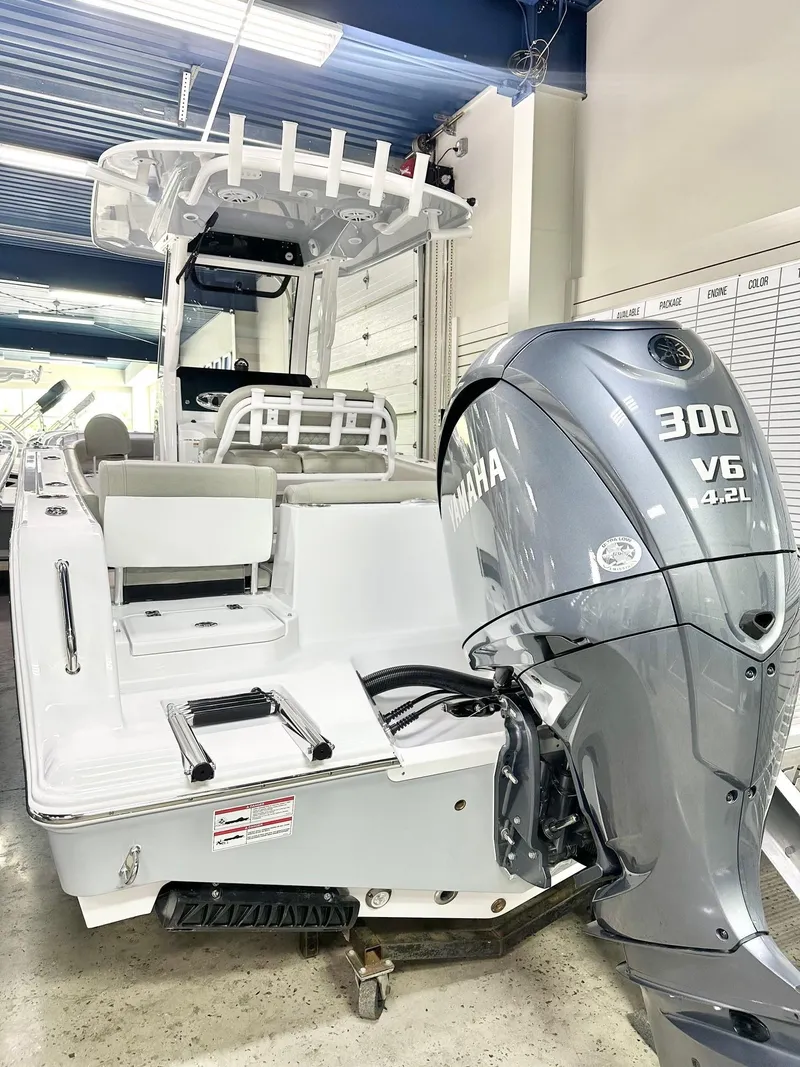 Slide: The Image of 2025 Sportsman Heritage 231 Center Console boat with Yamaha 300 V6 engine in showroom. - 12
