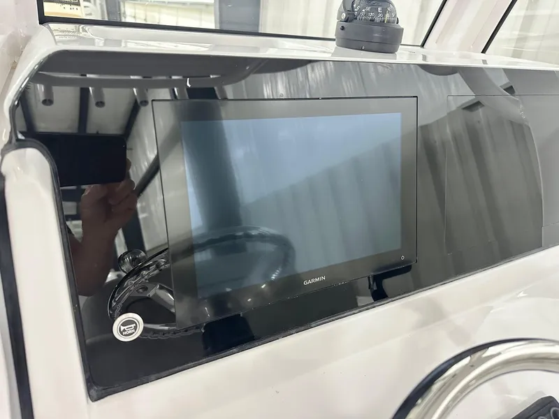 Slide: The Image of 2025 Sportsman Heritage 231 Center Console dashboard with Garmin display and steering wheel. - 3