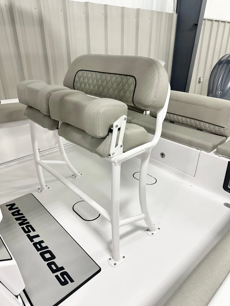 Slide: The Image of 2025 Sportsman Heritage 231 Center Console boat interior with cushioned seating and sleek design. - 4