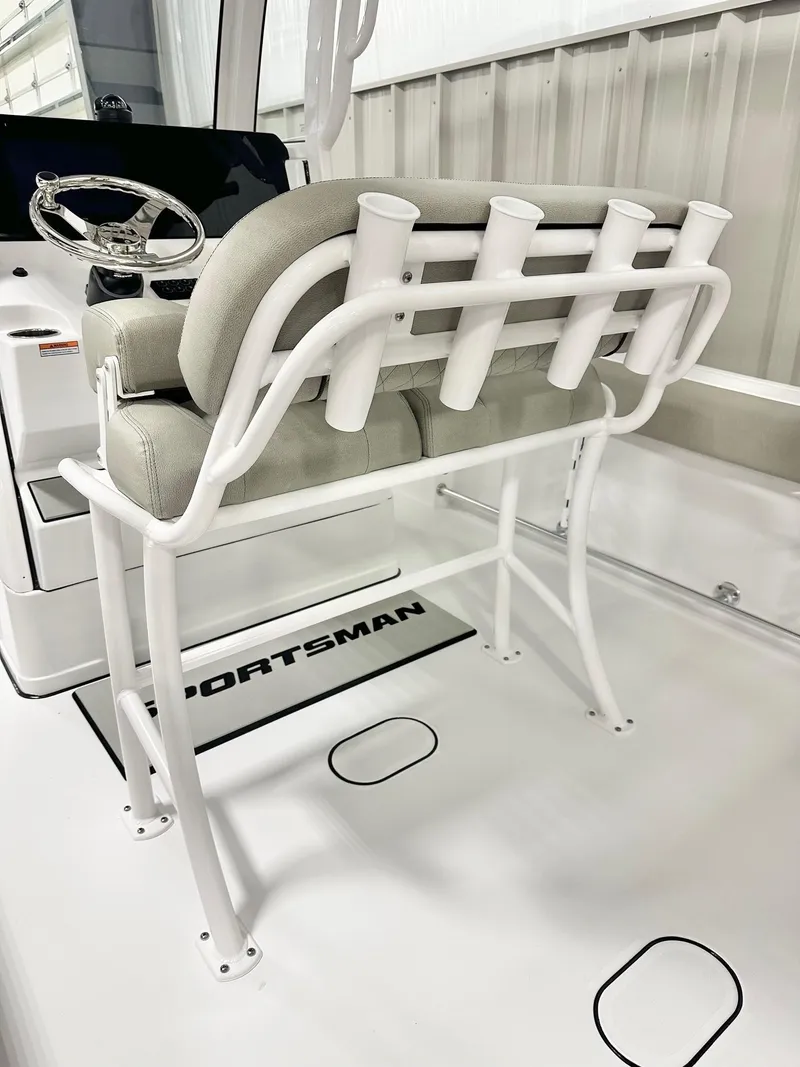 Slide: The Image of 2025 Sportsman Heritage 231 Center Console boat interior with cushioned seating and rod holders. - 5