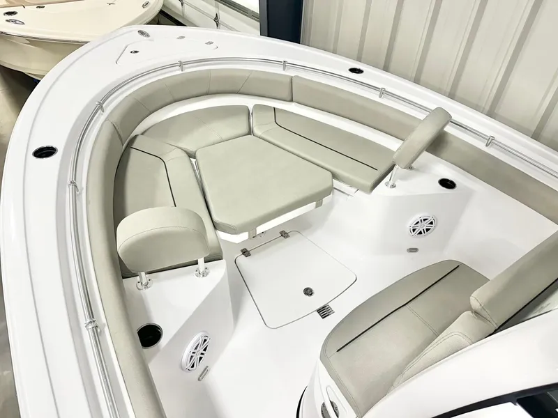 Slide: The Image of 2025 Sportsman Heritage 231 Center Console boat interior with cushioned seating and speakers. - 6