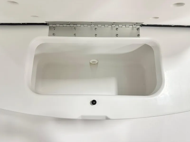 Slide: The Image of 2025 Sportsman Heritage 231 Center Console storage compartment, open lid, white interior. - 9