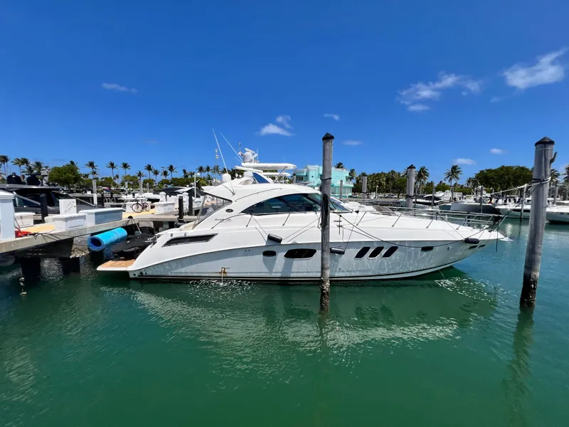 The Image of 2010 Sea Ray 540 Sundancer yacht docked in a sunny marina. - 0