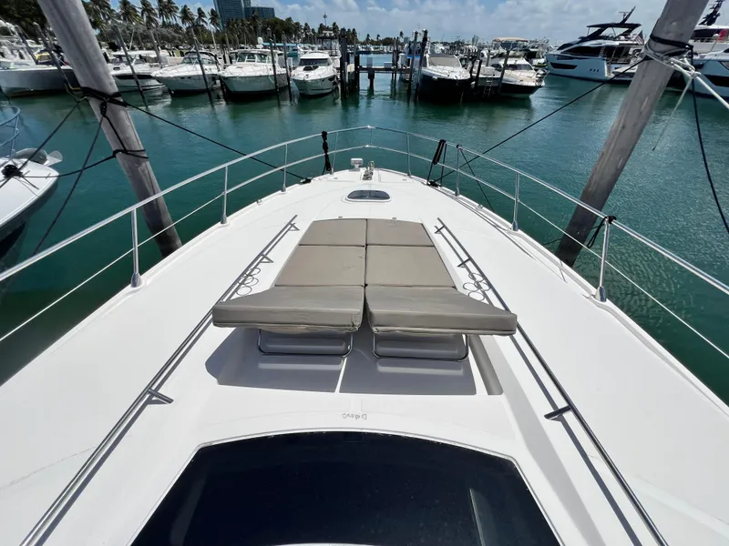Slide: The Image of 2010 Sea Ray 540 Sundancer yacht with sun loungers, docked in a marina. - 14