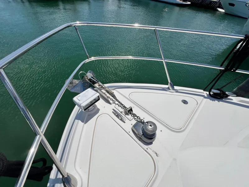 Slide: The Image of Bow of 2010 Sea Ray 540 Sundancer with anchor and railing, docked on calm water. - 15