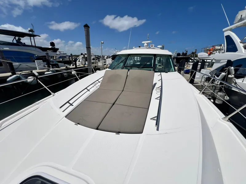 Slide: The Image of 2010 Sea Ray 540 Sundancer yacht docked at marina under clear blue sky. - 16