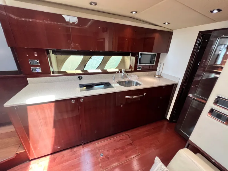 Slide: The Image of Luxurious kitchen interior of 2010 Sea Ray 540 Sundancer yacht with modern amenities. - 21