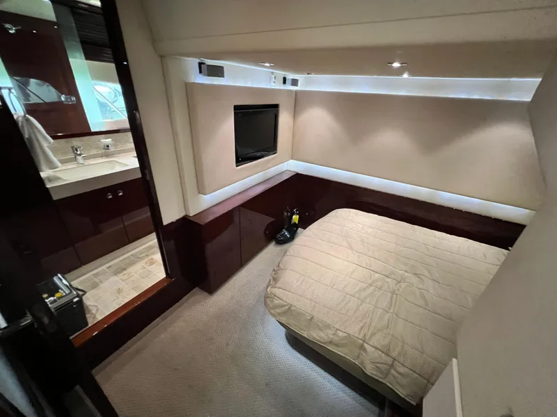 Slide: The Image of Luxurious cabin interior of 2010 Sea Ray 540 Sundancer yacht with bed and TV. - 22