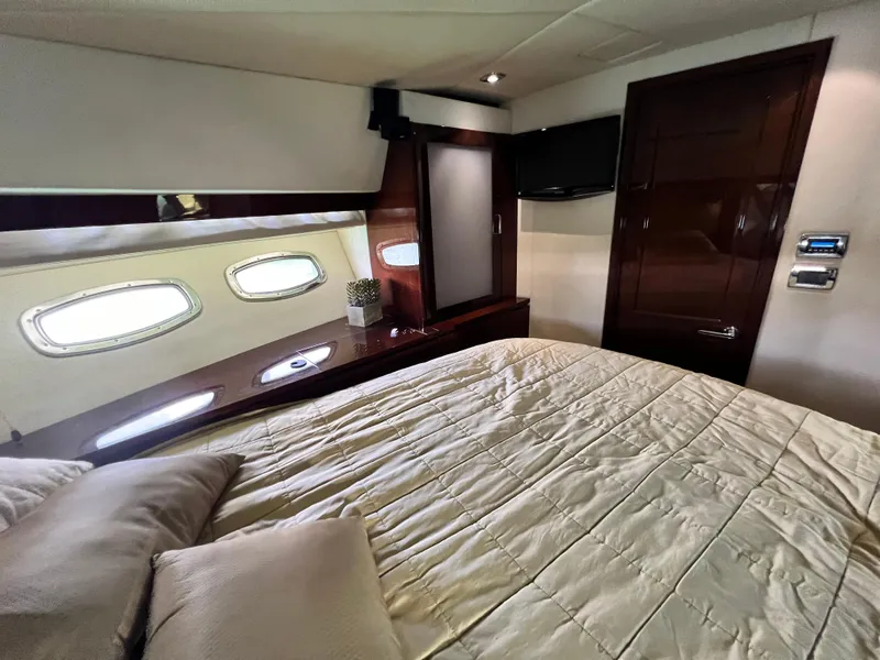 Slide: The Image of Luxurious bedroom interior of 2010 Sea Ray 540 Sundancer yacht with elegant wood finishes. - 29
