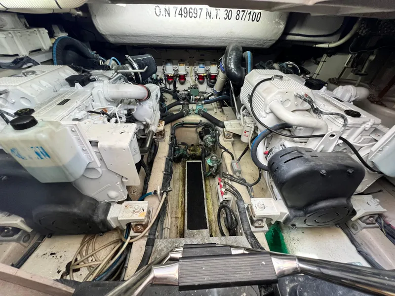 Slide: The Image of Engine room of 2010 Sea Ray 540 Sundancer yacht, showcasing dual engines and mechanical components. - 34