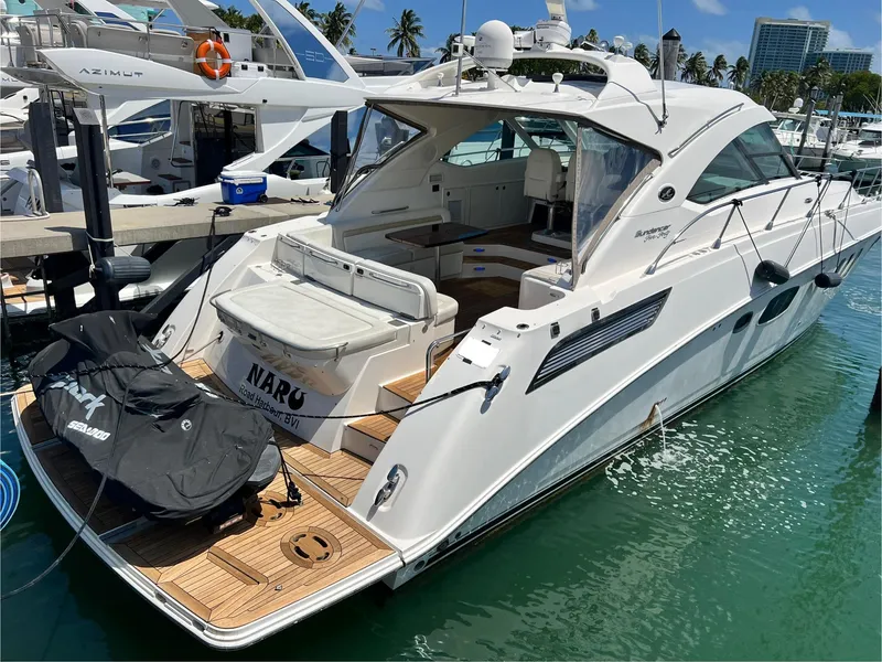 Slide: The Image of 2010 Sea Ray 540 Sundancer yacht docked at marina, featuring sleek design and spacious deck. - 6