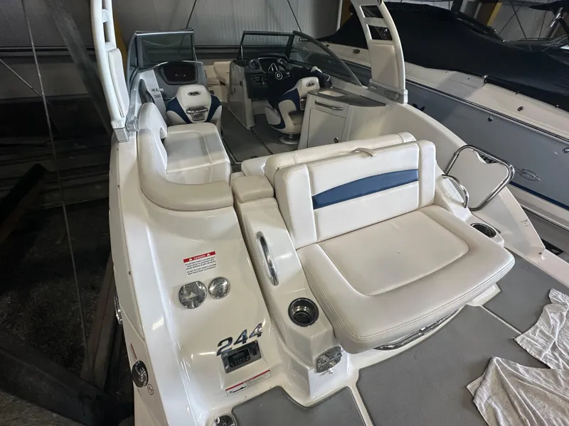 Slide: The Image of 2018 Chaparral 244 Sunesta boat interior with white seating and modern dashboard. - 19