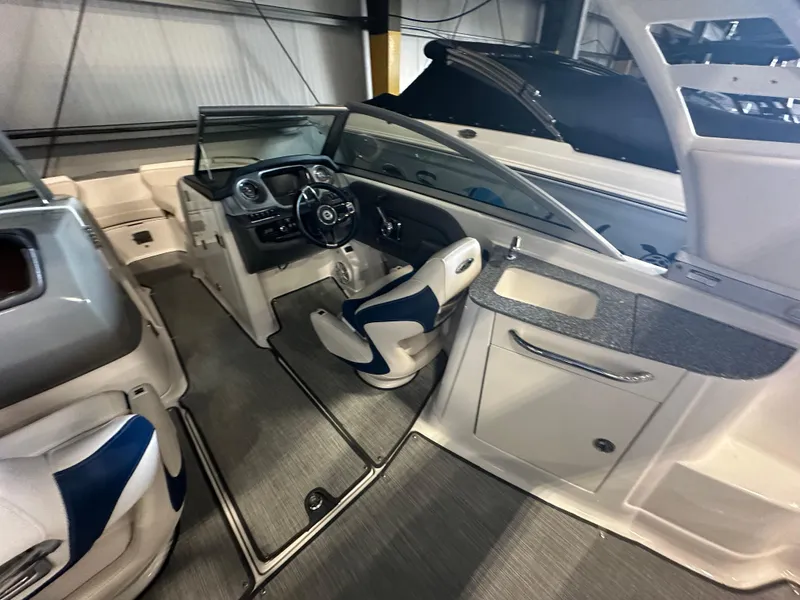 Slide: The Image of 2018 Chaparral 244 Sunesta boat interior with modern dashboard and seating. - 23