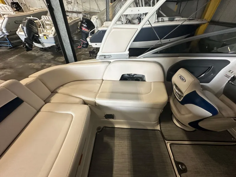 Slide: The Image of 2018 Chaparral 244 Sunesta boat interior with beige seating and modern design. - 25