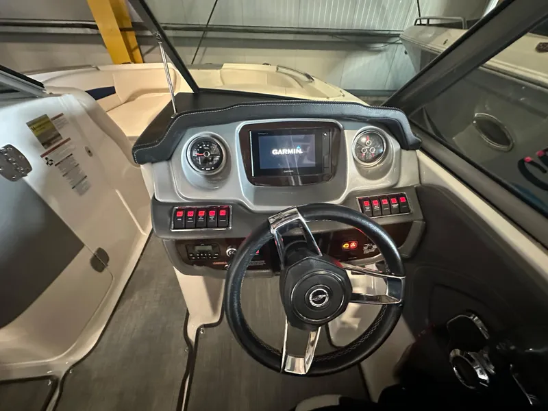 Slide: The Image of 2018 Chaparral 244 Sunesta boat dashboard with Garmin display and steering wheel. - 27