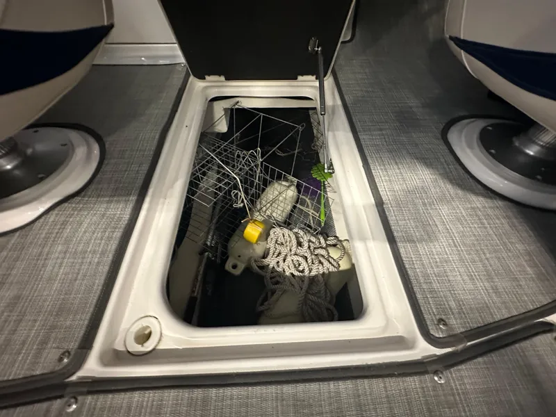 Slide: The Image of Storage compartment on 2018 Chaparral 244 Sunesta boat with ropes and equipment. - 28