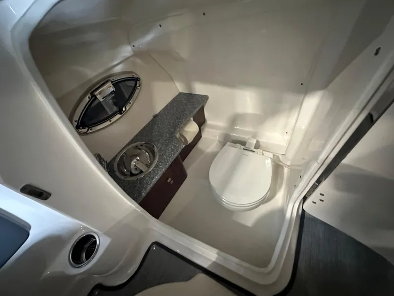 Slide: The Image of 2018 Chaparral 244 Sunesta boat interior with compact bathroom and sink. - 29