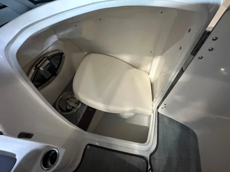 Slide: The Image of 2018 Chaparral 244 Sunesta boat interior with compact toilet compartment. - 31