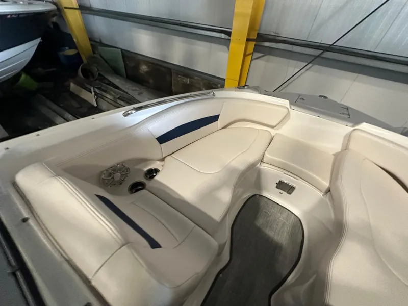 Slide: The Image of 2018 Chaparral 244 Sunesta boat interior with beige seating and cup holders. - 36