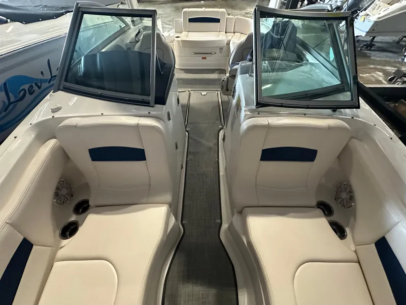 Slide: The Image of 2018 Chaparral 244 Sunesta boat interior with white seating and open windshield. - 38