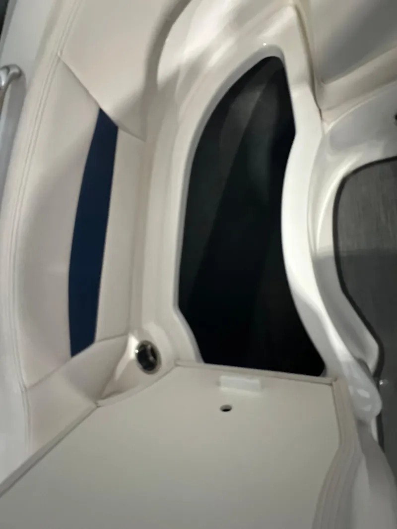 Slide: The Image of 2018 Chaparral 244 Sunesta boat interior with white and blue seating. - 40